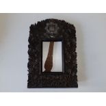 A carved wooden strut photo frame - 'Devonshire Regiment', decorated leaves, 12.25" high.