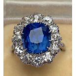 A certified natural 5.28 carat Sri-Lankan sapphire & diamond cluster ring set in unhallmarked