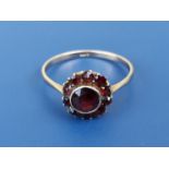 An Edwardian 9ct gold Bohemian garnet cluster ring. Finger size P.