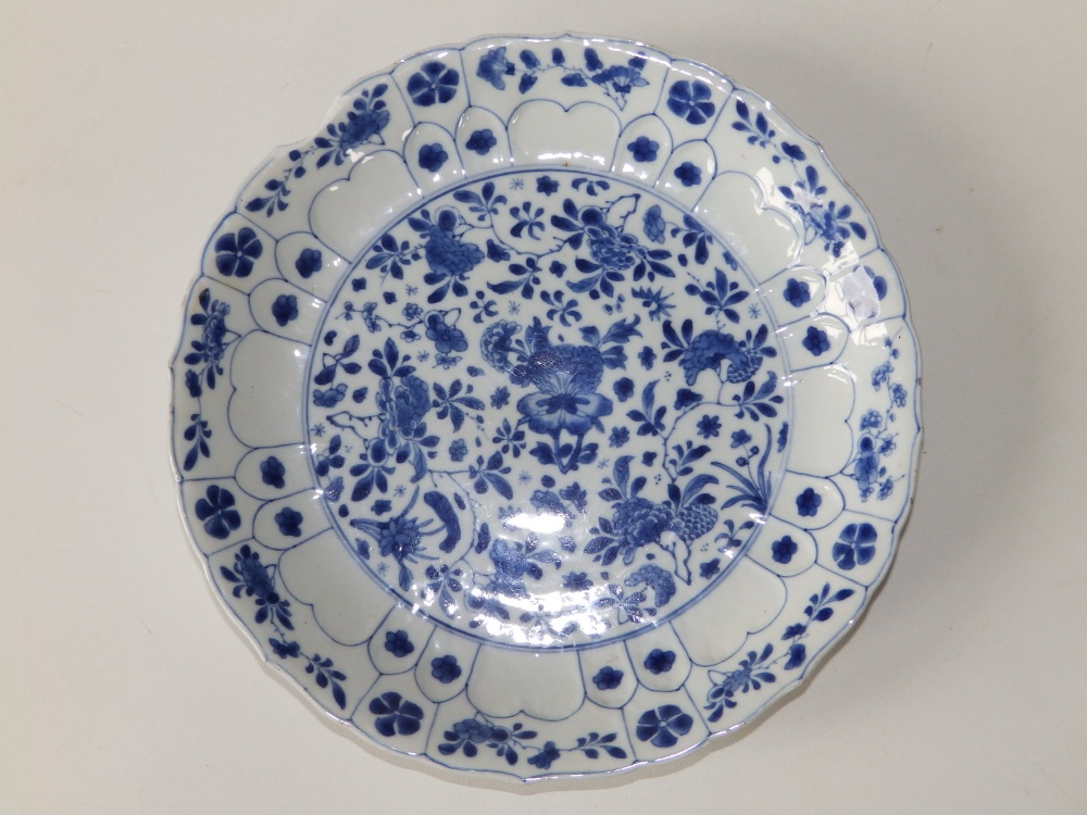 A Chinese Kangxi blue & white porcelain dish, having fluted rim, the central panel decorated overall