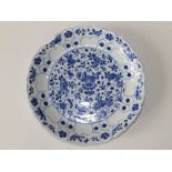 A Chinese Kangxi blue & white porcelain dish, having fluted rim, the central panel decorated overall