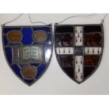 Two stained glass leaded light heralic shield panels - one inscribed 'Dominus illuminatio mea', 9"