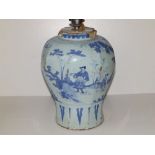 An 18thC delft blue & white vase, of octagonal inverted baluster shape, painted with chinoiserie