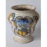 An 18thC continental maiolica jar, probably Italian, decorated with a cartouche depicting a