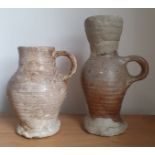 A 15thC pottery tankard, 6" high together with a restored example. (2)