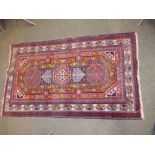 A Caucasian rug of latch hook medallion design, 37" x 62" and a red ground medallion rug of