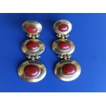 A pair of 750 yellow metal drop earrings, comprising three oval sections set with coral cabochons,