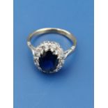 An oval sapphire & diamond cluster ring on yellow 18ct shank. Finger size L.
