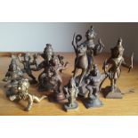A collection of nine small antique Indian brass figures - the largest 4.5" high