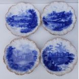 A set of four flow blue pottery plates with gilt scalloped borders, decorated with 'castle' scenes