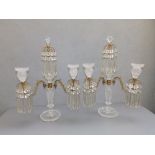 A pair of Regency cut glass ormolu mounted lustre candelabra, each having twin branches about a