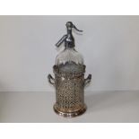 An etched soda syphon - 'Vinnicombe & Son - Torquay & Teignmouth' in EP openwork holder.