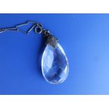 An art deco faceted pear drop crystal pendant on long bar link chain.