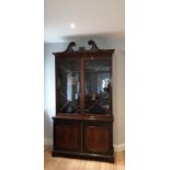 An Edwardian mahogany two stage bookcase in Edwards & Roberts style, the open fret swan neck
