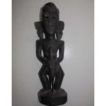 A tribal carved wood male figure, 16.5" high.