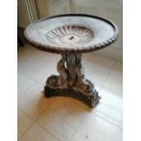 A 19thC lead dolphin fountain base, the fluted circular reservoir supported by three dolphins