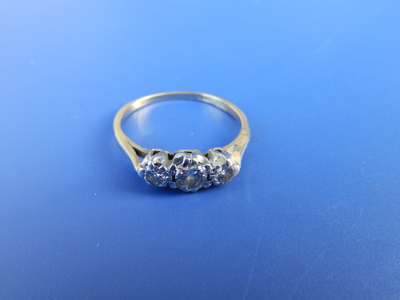 A small three stone diamond ring. Finger size L.