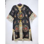 An early 20thC Chinese embroidered black silk robe, decorated with circular panels depicting