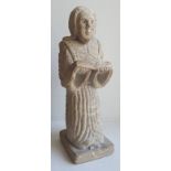 A pale stone figure of a robed male reading, on shallow square plinth, 7.5" high.