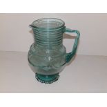 A 19thC American aquamarine glass pitcher having trailed decoration, with frilled footrim,