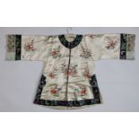 An early 20thC Chinese embroidered cream silk robe, decorated with flowering branches, the black