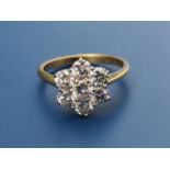 A modern diamond daisy cluster set 18ct gold ring, total diamond weight approximately one carat.