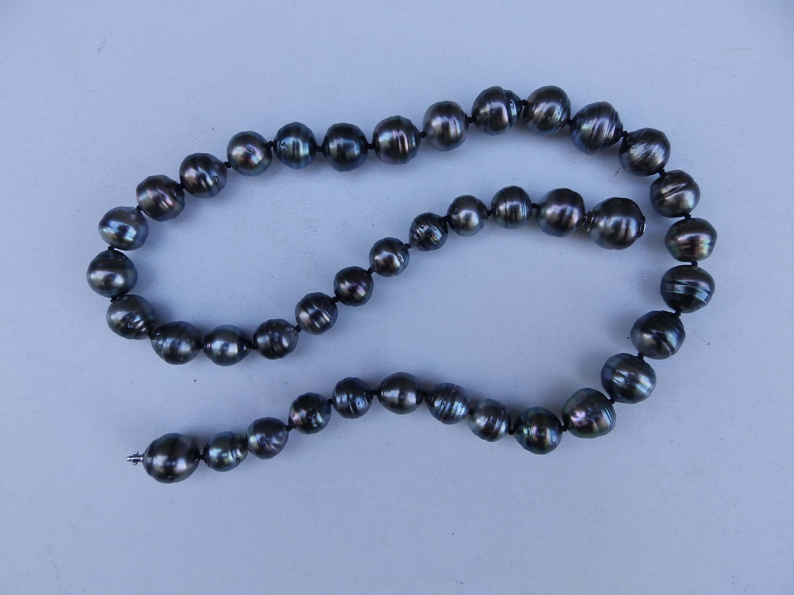 A necklace of black Tahitian 'circle' pearls, having concealed 750 white metal fastener, maximum