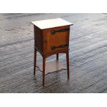 An Arts & Crafts oak smoker's cabinet, the door with embossed copper strap hinges, on straight