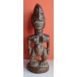 An antique Yoruba Ibeji wooden figure, 9" high.