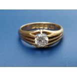 A diamond solitaire set band ring, the claw set stone weighing approximately 0.65 carat. Finger size