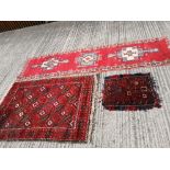 An Oriental red ground medallion runner, a rug and a mat. (3)