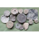 A collection of excavated mediaeval and later lead weights, some with markings.