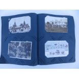 An old postcard album containing approximately 132 cards.