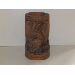 A Chinese carved bamboo brush pot, decorated with a tiger, 8.75" high.