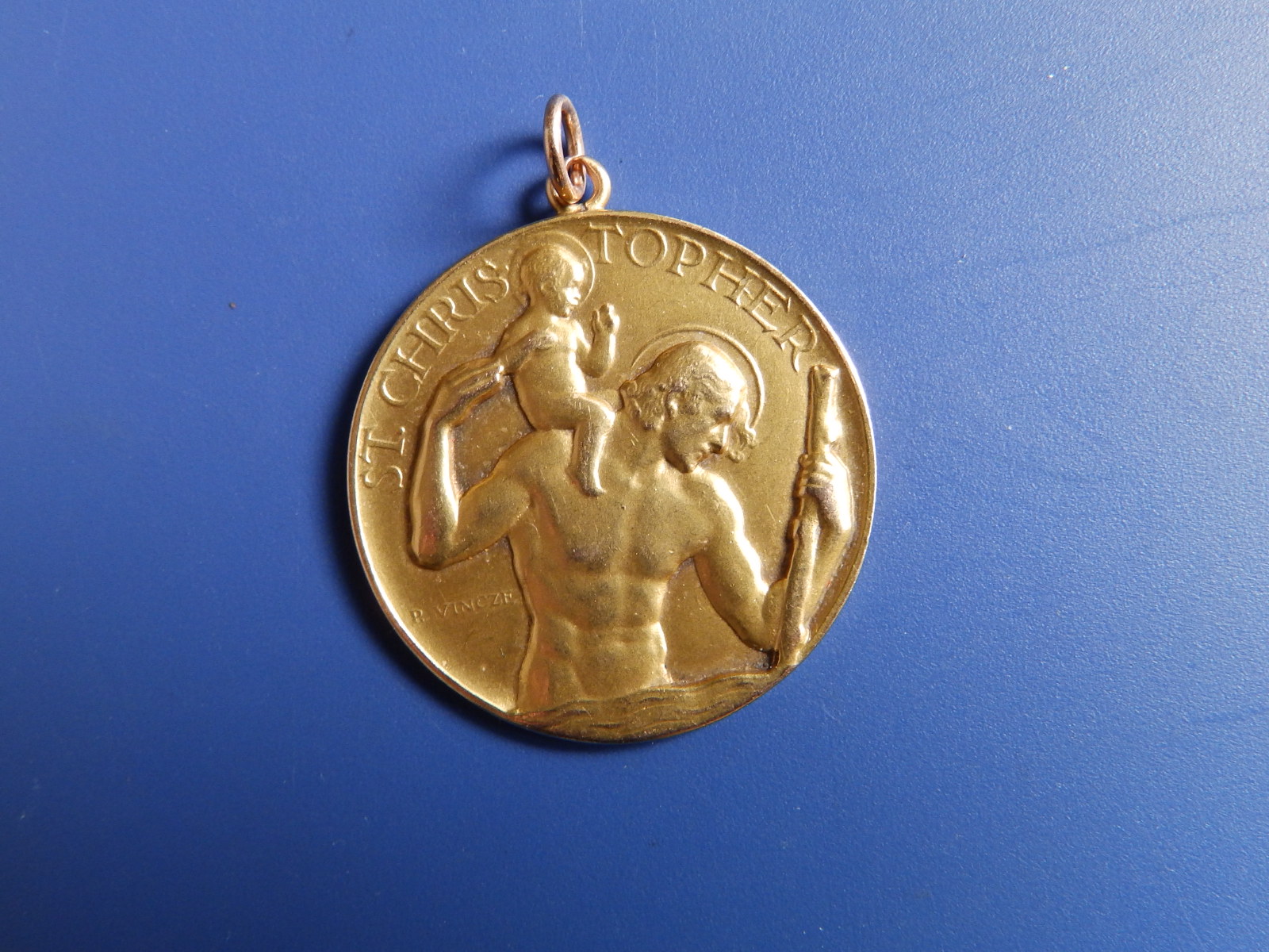 A 9ct gold St. Christopher medallion by Paul Vincze, engraved to verso 'When I am far from those I