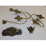 A pair of brass curtain ties, another pair and two small brass cherub plaques. (6)