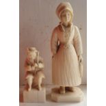 A late 19thC continental ivory figure of a woman holding two fish, 4.25" high and another