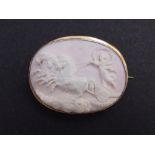 An oval pale pink shell cameo gold brooch, depicting Aurora with her chariot, 2.1".