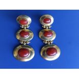 A pair of 750 yellow metal drop earrings, comprising three oval sections set with coral cabochons,