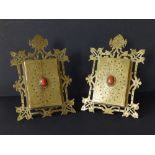 A pair of late 19thC Gothic Revival brass folding easel photo frames, having oval hardstone