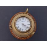 A small ship's style wall clock, 6.25" overall diameter.