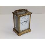 A brass carriage clock, 4.5" high excluding handle - dial & movement a/f.