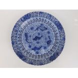 A Chinese blue & white porcelain plate, the scalloped rim decorated with stylised flowerheads, the