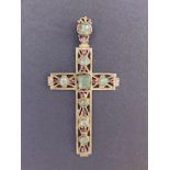A silver gilt cross pendant set with pale emeralds & small rubies, 3.8" overall.