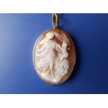 An oval shell cameo set gold pendant depicting the birth of Pallas Athene, 1.5" high.