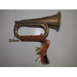 A 20thC brass bugle.