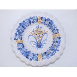 An 18thC delft fluted tulip dish, decorated in underglaze blue & ochre, 12" diameter.