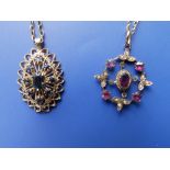 Two 9ct gold gem set openwork pendants on necklace chains.