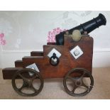A 19thC signal cannon on wooden carriage with bronze wheels and mounts, cannon length 12", total