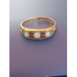 A small opal & ruby set 9ct gold ring - London marks. Finger size N/O.